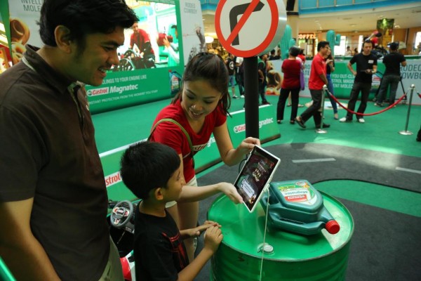 Little boy and his father were learning the car engine protection via Augmented Reality technology